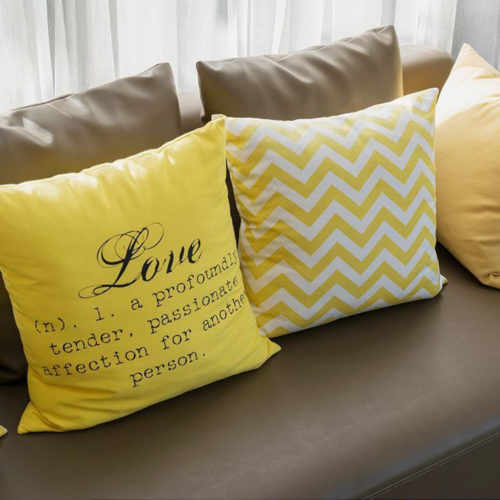 modern living room design with brown sofa and yellow pillows